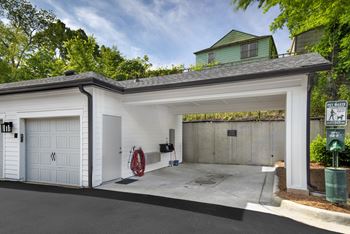 A two-car garage with a white door and a red fire hose.